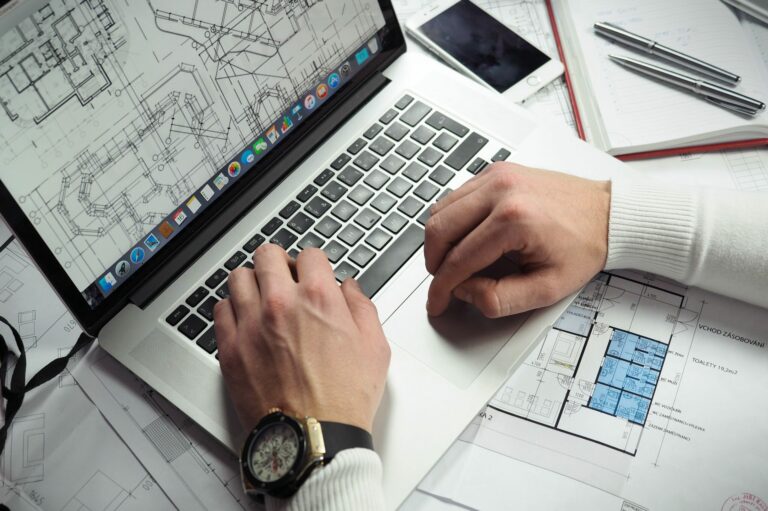 Mains d'un étudiant en Architecture travaillant sur son ordinateur portable